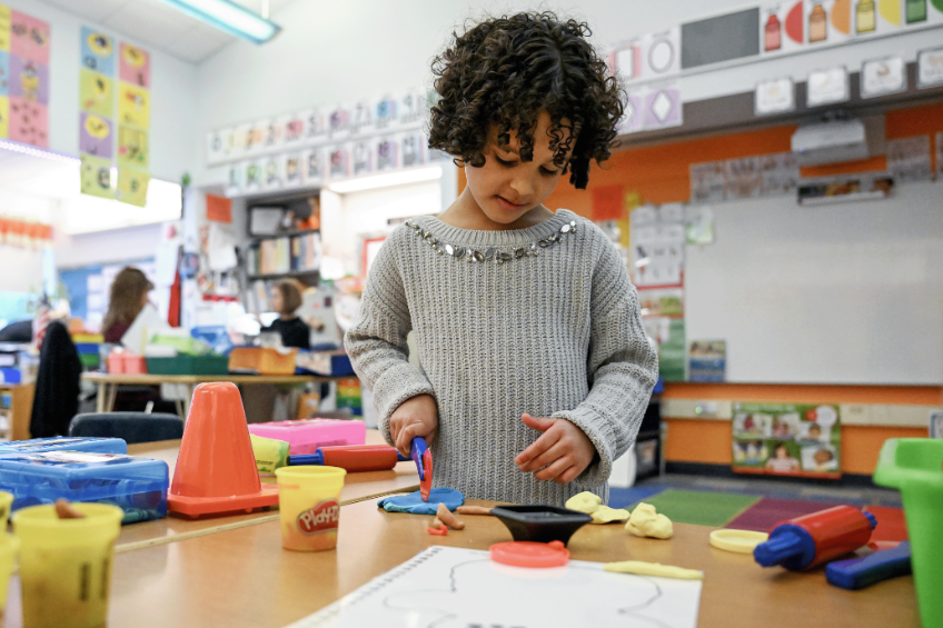 Student playing with playdough