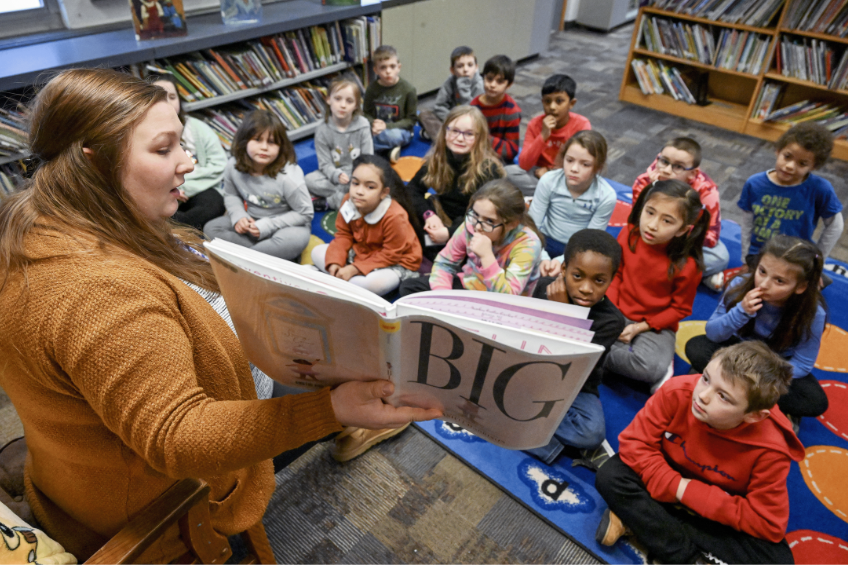 Librarian reading to students