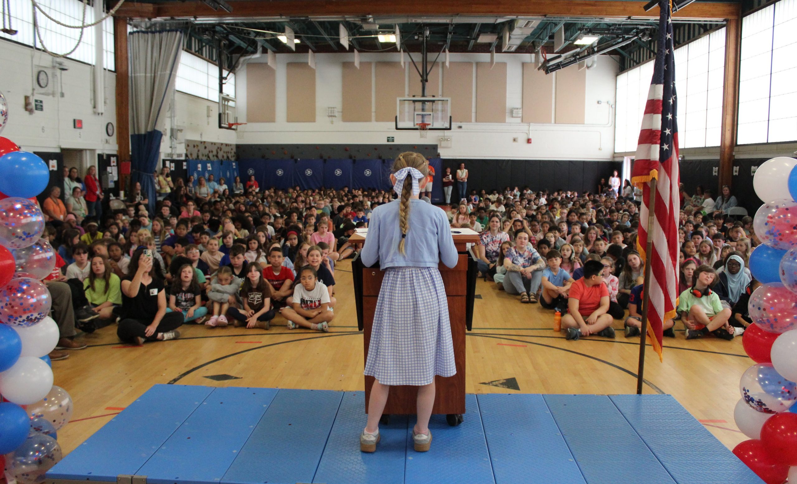 Student reading her speech at a ceremony