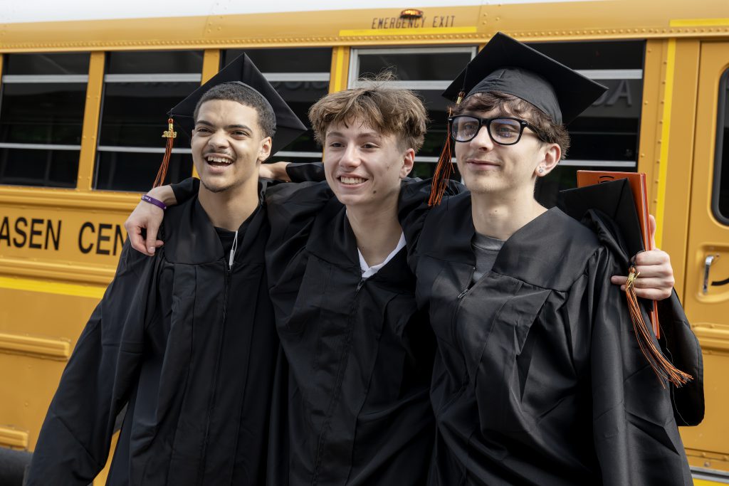 three students at graduation 